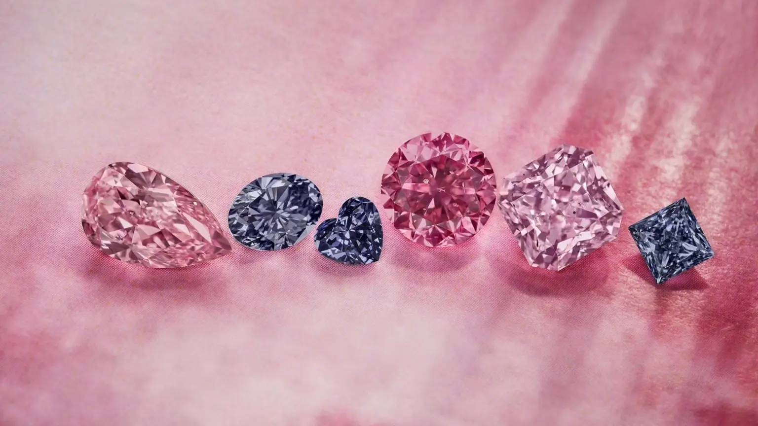 Argyle pink, purple and blue diamonds arranged on pink silk