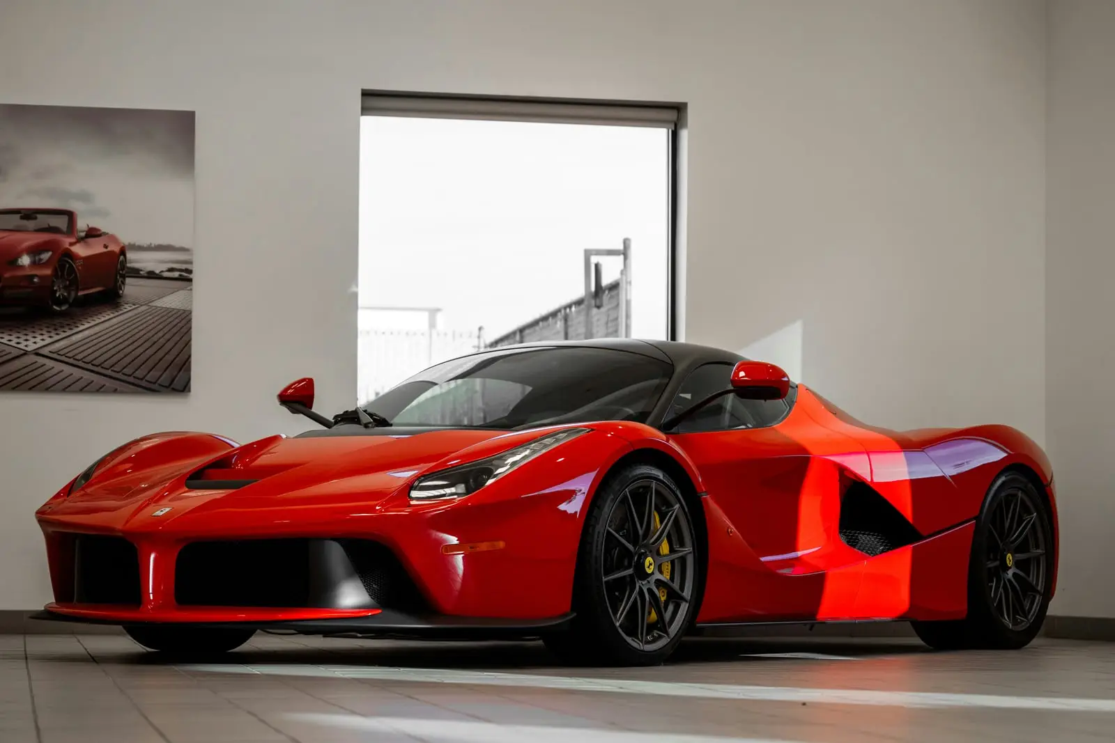Red Ferrari LaFerrari displayed in a showroom